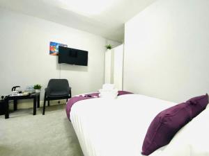 a bedroom with a bed and a desk and a television at Blackpool - Seaside in Blackpool