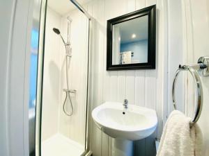 a white bathroom with a sink and a shower at Blackpool - Seaside in Blackpool