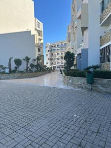 an empty street in a city with tall buildings at Appartement spacieux, très calme in Casablanca