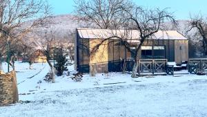 a small building with snow on the ground at Princess Ślęża in Sady