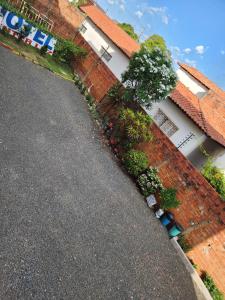 a house with a brick wall and a driveway at Condomínio Center luz in Teresina