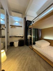a bedroom with a bunk bed and a lamp at One More Space in Chiang Mai