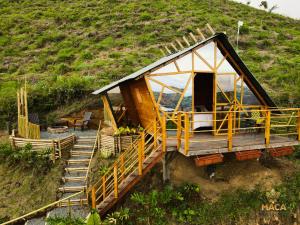 a small house on the side of a hill at MACA GLAMPING in Calima
