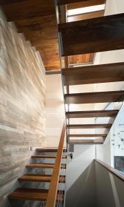 a staircase in a house with wooden ceilings at Villabellosa in Villar de Plasencia