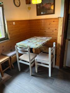 a room with a table and two chairs and a table at Hiška pri Vrjaku in Bohinjska Bistrica +11 photos