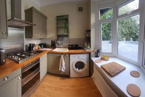a kitchen with a washing machine in the middle at Spacious Guest Flat near Roundhay Park in Roundhay