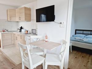 a small kitchen and dining room with a table and chairs at Balaton Apartman Füred in Balatonfüred