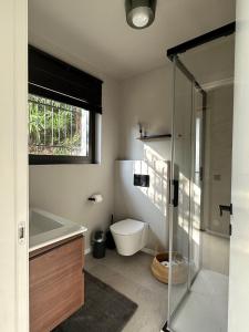 a bathroom with a toilet and a sink and a shower at Casa Del Sole in Agra +28 photos