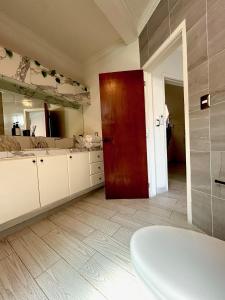 baño con puerta roja y 2 lavabos en Casa boka con vista al mar y alberca, en Boca del Río