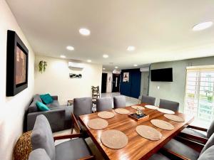 a dining room with a table and a couch at Casa boka con vista al mar y alberca in Boca del Río