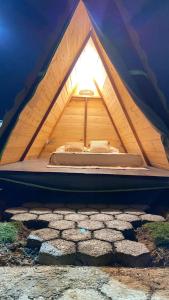 a bed in a tent with a light in it at A Chave da Montanha 