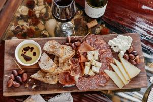 a cutting board with cheese and meats and other foods at Catalina's Hideaway in Santa Catalina