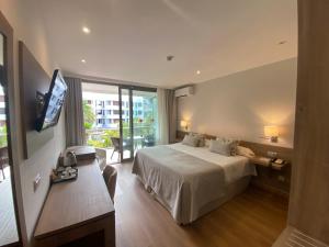 a hotel room with a bed and a television at Hotel Colon Rambla in Santa Cruz de Tenerife