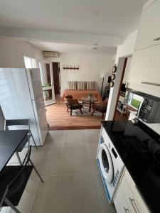 a kitchen and living room with a stove top oven at Casa moderna y recién terminada in Maldonado