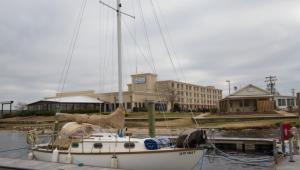 a boat docked at a dock in front of a building at BridgePointe Hotel & Marina in New Bern