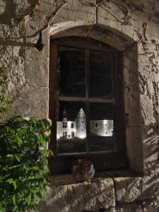 una ventana en un edificio de piedra con un castillo en 2 Suites dans demeure authentique du XVÈME 