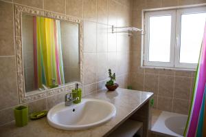 a bathroom with a sink and a mirror and a tub at Casa Ardomar in Carrapateira +15 photos