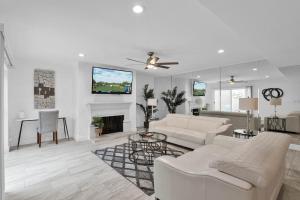 a living room with white furniture and a fireplace at Private Patio, Close To Pool & Clubhouse Walkable in Scottsdale