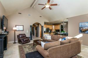 a living room with two couches and a ceiling fan at Riviera Retreat in Salt Lake with Private Hot Tub and Theater in Millcreek