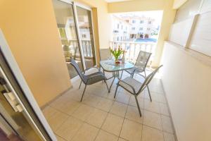 a small balcony with a glass table and chairs at 1 bed, Kapparis, Thea - 1B in Paralimni