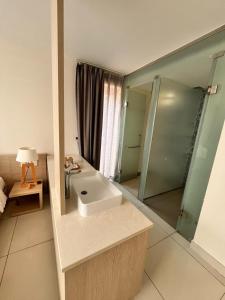 a bathroom with a sink and a glass shower at Villa biển Oceanami B805 - Ô tô đậu trước cửa nhà in Long Hai