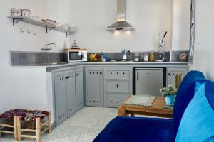 a kitchen with a blue couch and a microwave at What a View ! On the top of the Castle / Kasbah. in Tangier