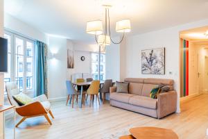 un soggiorno con divano e tavolo di Luxueux Appartement Design 70m2 Disneyland Paris pour 6pax a Chessy