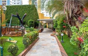 a garden with a statue in the middle of a walkway at Temporada Thermas Place Suítes Caldas Novas in Caldas Novas