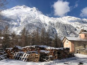 a building in the snow with a snow covered mountain at LA DENT PARRACHEE in Termignon