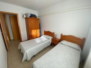 a bedroom with two beds and a cabinet at Eco tourist in Riumar