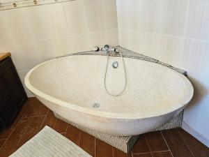 a large white bath tub in a room at VILLA VALIHA in Koungou