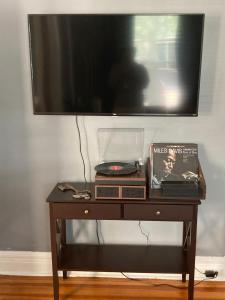 a wooden table with a tv on top of it at Perfect for Families and Traveling Professionals in Albany