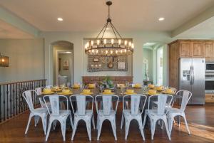 a dining room with a table and white chairs at 3| Grand View Estate in St George with Views and Lawn in Santa Clara