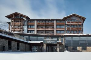 a large building with a sign in front of it at Hotel Wulfenia 4S - Adults Only in Sonnenalpe Nassfeld