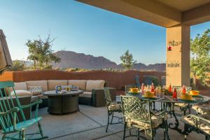a patio with tables and chairs and a couch at 3| Grand View Estate in St George with Views and Lawn in Santa Clara