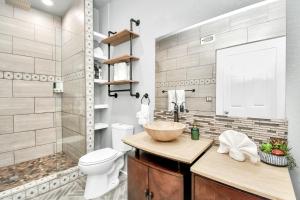 a bathroom with a sink and a toilet and a shower at Nautical Loft with Outdoor Kitchen & Beach Access in Galveston