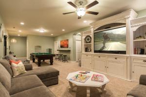 a living room with a tv and a pool table at 3| Grand View Estate in St George with Views and Lawn in Santa Clara