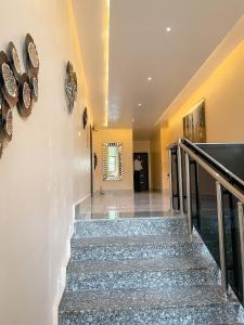 a staircase in a house with a stair case at ADDRESS HOTELS AND TOWERS MAITAMA in Abuja