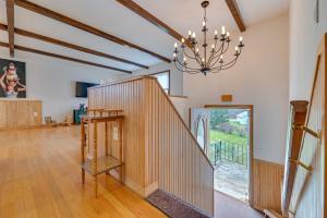 a living room with a staircase and a chandelier at Vacation Rental Home about 2 Mi to Windham Mountain! in Windham