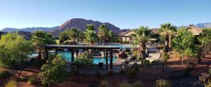 an aerial view of a resort with a pool and palm trees at 85| Southern Comfort in St George with Hot Tub in Santa Clara