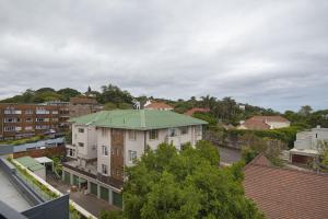 a building with a green roof in a city at 707 at 2SIX2 Florida Road by HostAgents in Durban