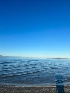 a person walking on the beach near the water at Eco tourist in Riumar