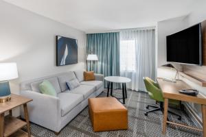 a living room with a couch and a table at Staybridge Suites Denver - Cherry Creek, an IHG Hotel in Denver