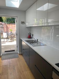 a kitchen with a sink and a counter top at Arden on Albert in Beverley