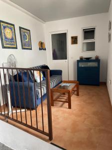 a living room with a couch and a table at Casa Sol y Luna in Alozaina