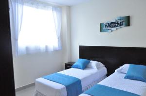 Postel nebo postele na pokoji v ubytování Valdivia Suites