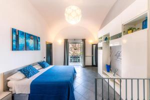 a bedroom with a blue bed in a room at Maika House - Amalfi Coast - Seaview in Atrani