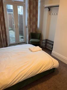 a bedroom with a bed and a chair and a window at Luxury Cosy Retreat Apt in London