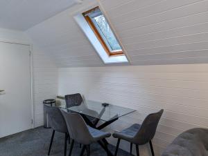 a dining room with a glass table and chairs at Epona 8 - Hot Tub-Perth-Pets-Luxury in Perth +10 photos