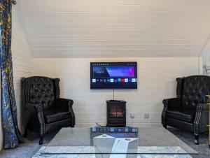 a living room with two chairs and a tv at Epona 8 - Hot Tub-Perth-Pets-Luxury in Perth